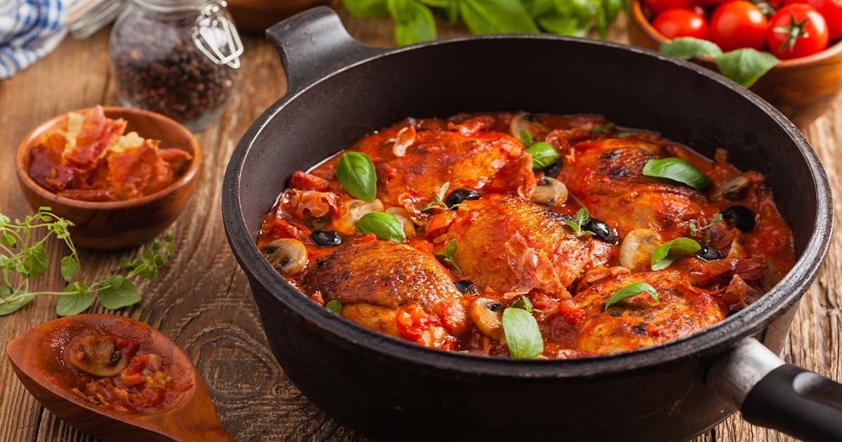 Chicken cacciatore - classic italian dish in a pot on a table